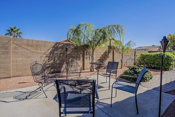 Enjoy laughter and conversation with friends or family out on this patio with comfortable seating and fire pit