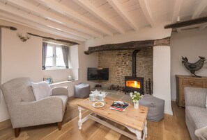 Vicarage Cottage, near Bridport: The cosy sitting room with inglenook fireplace