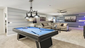 Comfortable space with a TV and pool table, providing a relaxed and entertaining atmosphere for guests