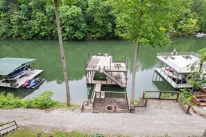Private 2 story dock with 2 slides, 2 picnic tables, chaise loungers, fire pit