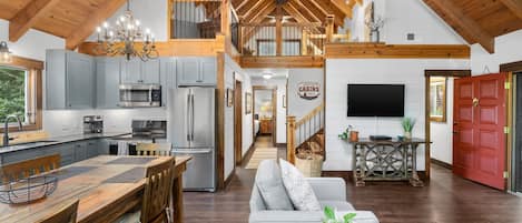 Main level living, dining, kitchen looking towards the upper level loft.