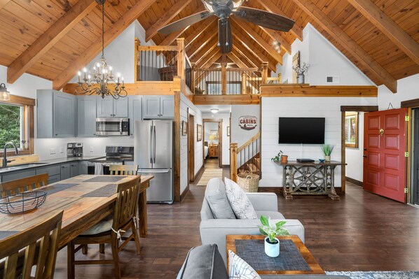 Main level living, dining, kitchen looking towards the upper level loft.