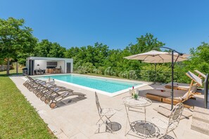 Private common pool, green garden and lounge area.