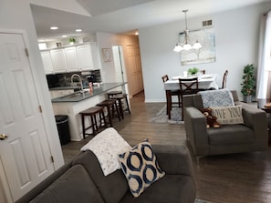 Open living & kitchen dining room floor plan that leads to  outside patio