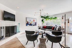 Open concept living area with fireplace and stunning pool views