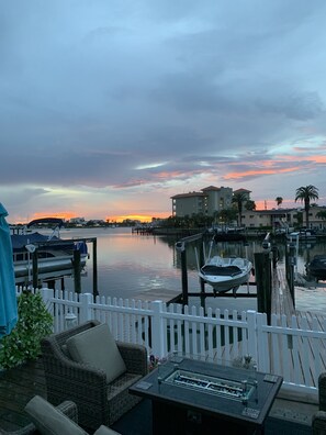 Back patio sunset view with gas, outdoor fireplace and hot tub