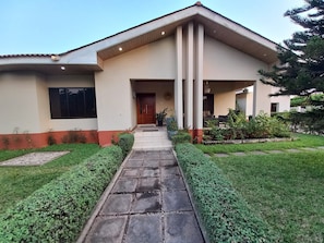 The front lawn is a colourful oasis that greets you with lush greenery.