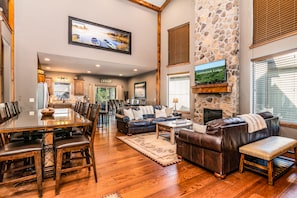 The living room welcomes you with 2 story vaulted ceilings & a stone fireplace!