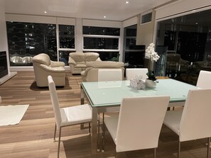 Level 2 living / dining area night view facing bay
