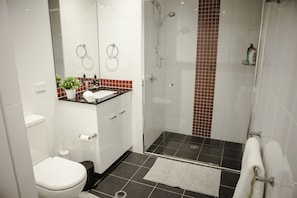 Bathroom with a toilet, sink and shower