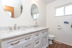 Beautifully updated full bathroom with double sinks and natural light.