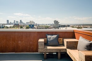 Rooftop bench seating with view of the Source and downtown Denver. 