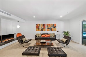 Spacious living room with cozy fireplace for playing games or reading a book.  