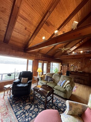 Cathedral ceiling living room with incredible lakefront view.
