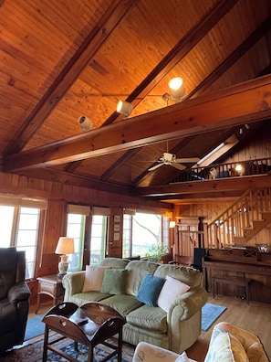 True lake house style with cathedral wood ceiling and wide beams