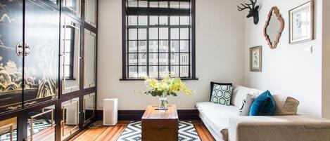 Large French windows in the living room allows for plenty of natural light. 
