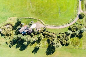 Aerial view of the Ranch House and 18 acre property with private road and creek