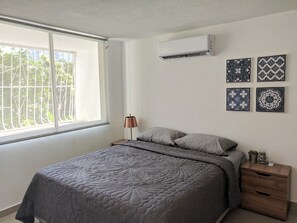 Bed room with queen sized bed and aircondition