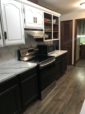 Kitchen with snazzy counters and stainless steel appliances