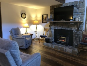 Comfortable Living Room with Wood Stove and Satellite TV