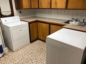 Partial kitchen-electric stove top, sink, mini fridge with freezer, washer/dryer