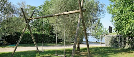 Swing, Tree, Property, Land Lot, Outdoor Play Equipment, Grass, Real Estate, Grass Family, Woody Plant, Park