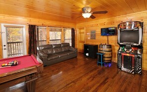 Lively rec room with pool table, arcade games, and snug seating.