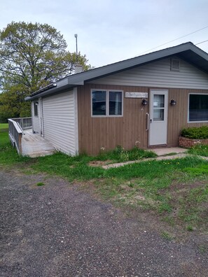 Deck wraps around to back of the house with a seating area.