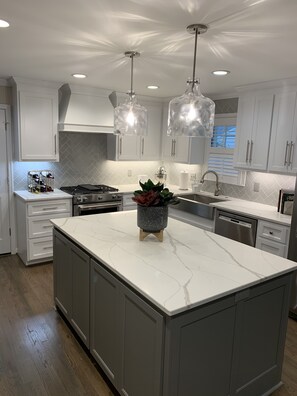 Gas stove top with two ovens in open kitchen