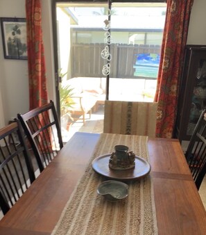 Dining room with teal table (sliding leaves to expand).  