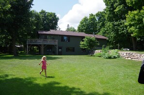 The large yard on the lakeside of the cabin has plenty of room for activities.