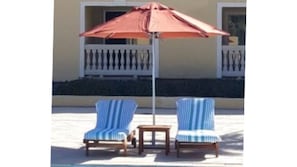 BEACH CHAIRS AND UMBRELLAS ON THE OCEAN AND AT THE INFINITY POOL FOR YOUR USE