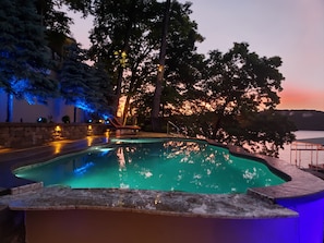 Pool at Sunset. Granite bar with seating in the pool and outside of pool.