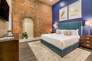 Spacious master bedroom with a king bed, ensuite bath, and designer built-in closets. Includes nightstands, lamps, hangers, luggage racks, alarm clock, white noise machine, and a 55'' Samsung Smart 4K TV with streaming and DIRECTV Entertainment.