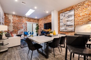 Open concept living, kitchen, and dining area with ample comfortable seating options for you and your guests.