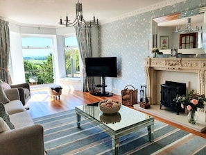 Living room: floor-to-ceiling windows, window seat and TV with Sky and Netflix