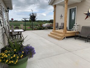 Back patio with several chairs and table.