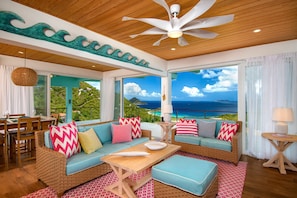 Open-plan living space with unique custom artwork to compliment the beachy vibe