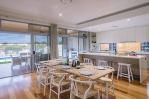 The open-plan kitchen, dining, and living area flows effortlessly to the alfresco space, creating the ultimate setting for entertaining. 