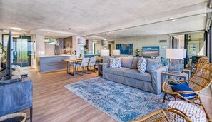 View of the open living space all the way through to the kitchen and entryway.