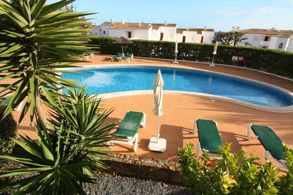 Gorgeous shared pool area with sun loungers, parasols and also a kids pool