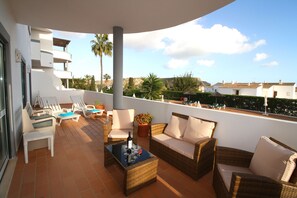 Spacious veranda has patio suite, sun loungers and a table & chairs