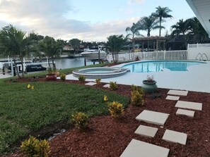Pool view and canal view from side of house