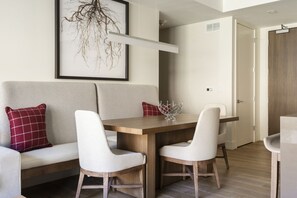 Chic dining room with seating for 6 between high back upholstered fabric and wooden chairs and a spacious dining bench