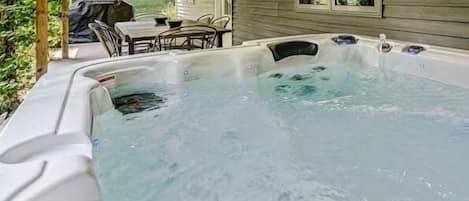 Looking out of the hot tub towards the dining area and grill of our shaded back patio.