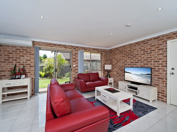 Lounge room that has access to rear courtyard.