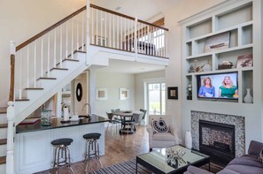 Open Living & Dining Area Features 2 1/2 Story Vaulted Ceiling & Balcony Loft