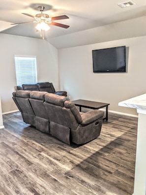 Couch and loveseat have four recliners in living room