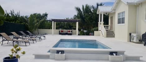 Pool and lounge area with gazebo,BBQ grill and a fire place.