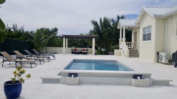 Pool and lounge area with gazebo,BBQ grill and a fire place.